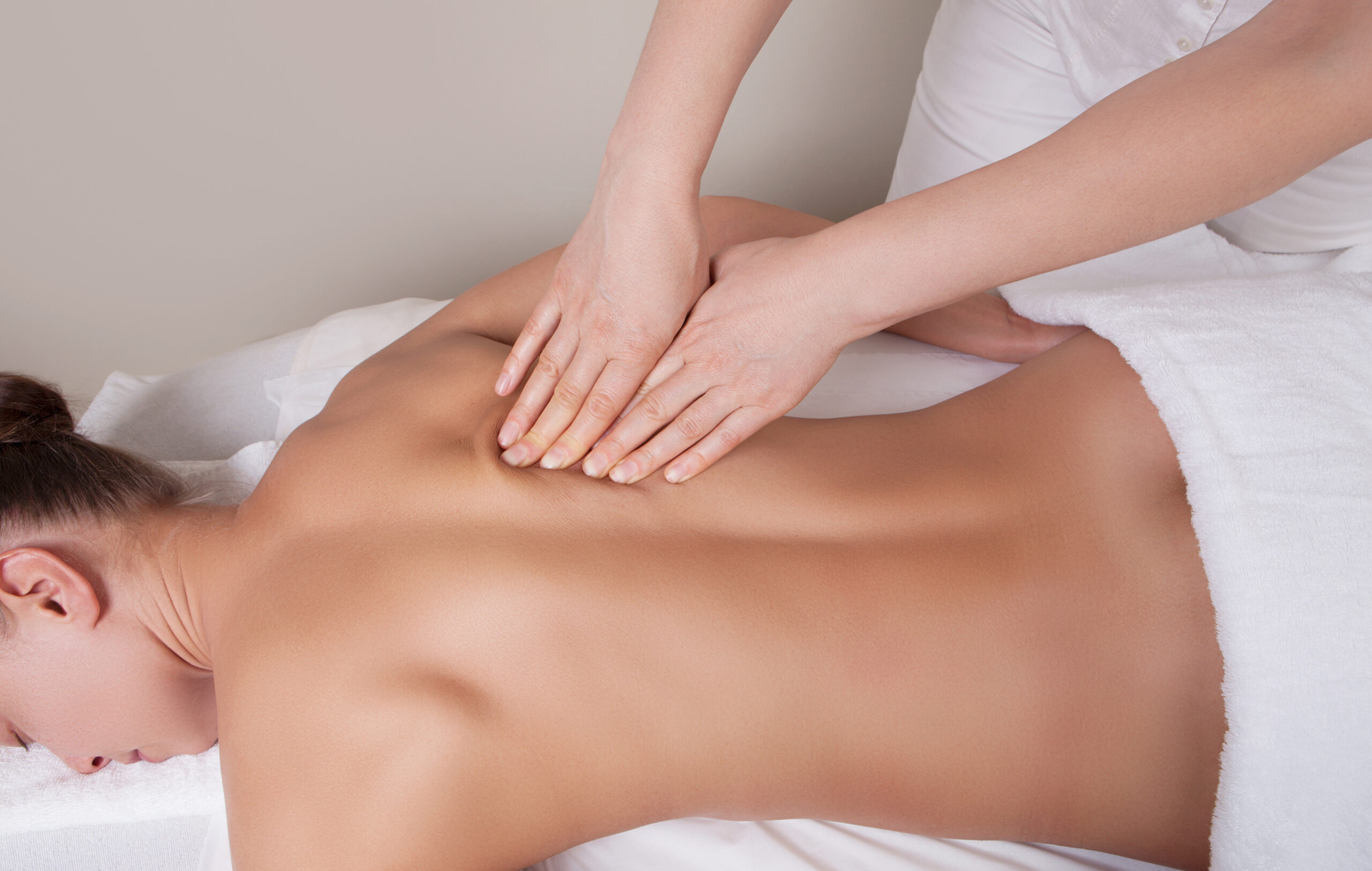 Connective tissue massage on a muscle group of a woman's back